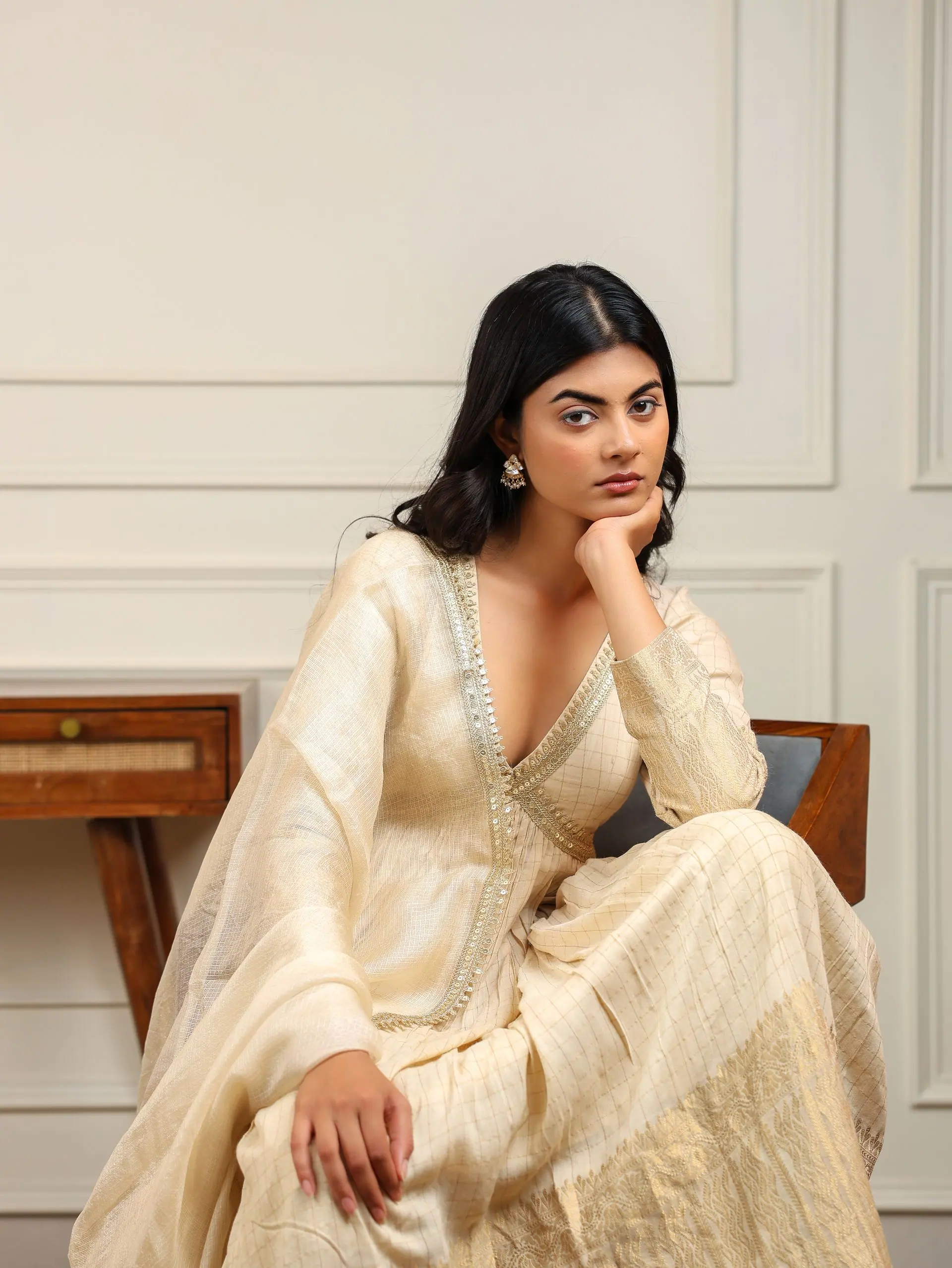Champagne tissue anarkali, chin resting on hand